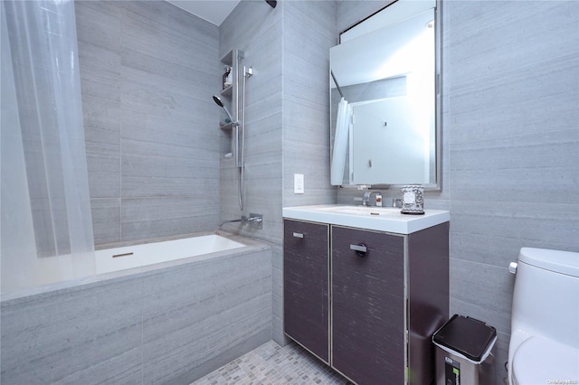 bathroom with tile patterned floors, vanity, toilet, and tile walls