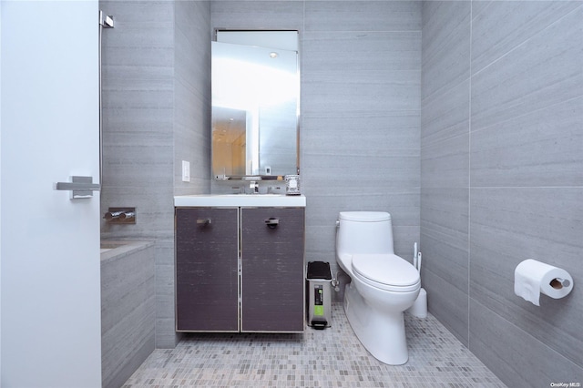 bathroom featuring tile patterned floors, vanity, and tile walls