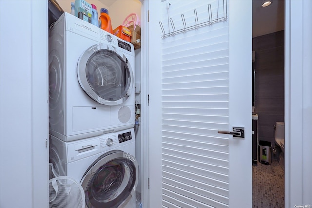 laundry area with stacked washer / dryer