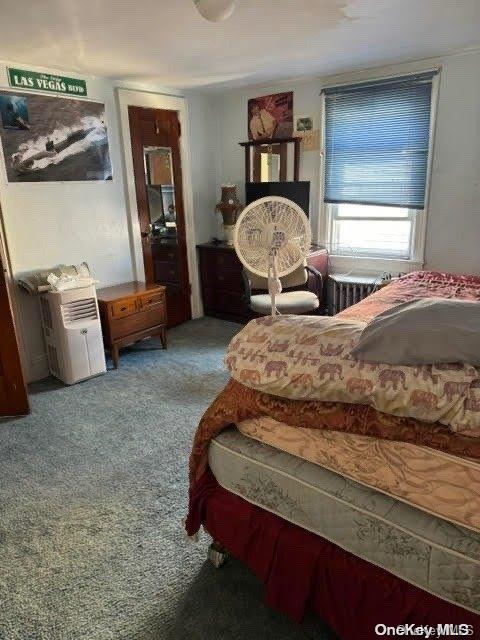 bedroom with light colored carpet