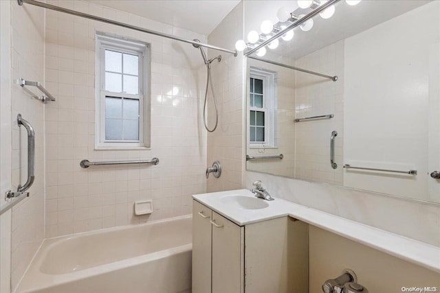 bathroom with vanity and tiled shower / bath