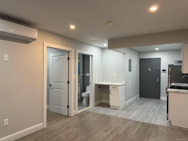 228 55th St Unit 3A, Brooklyn, NY 11220 - kitchen with light wood finished floors, light countertops, electric panel, white cabinets, and recessed lighting