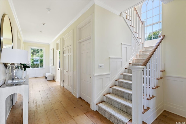 interior space with hardwood / wood-style flooring and ornamental molding