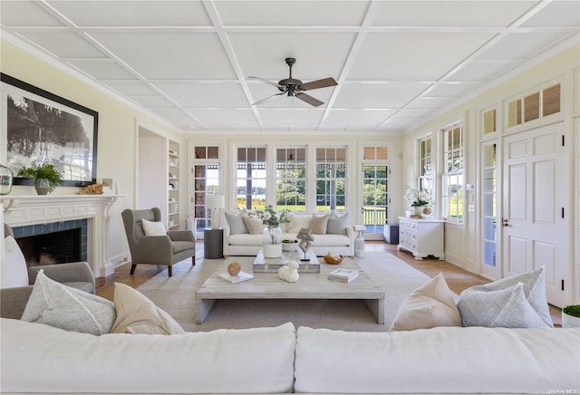 living room featuring ceiling fan, light hardwood / wood-style floors, and coffered ceiling