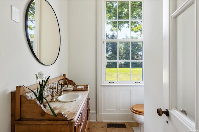 bathroom featuring vanity and toilet