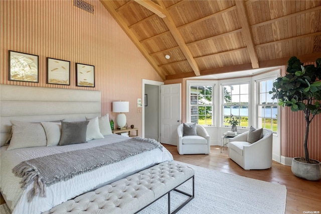 bedroom featuring wooden ceiling, beamed ceiling, high vaulted ceiling, a water view, and hardwood / wood-style flooring