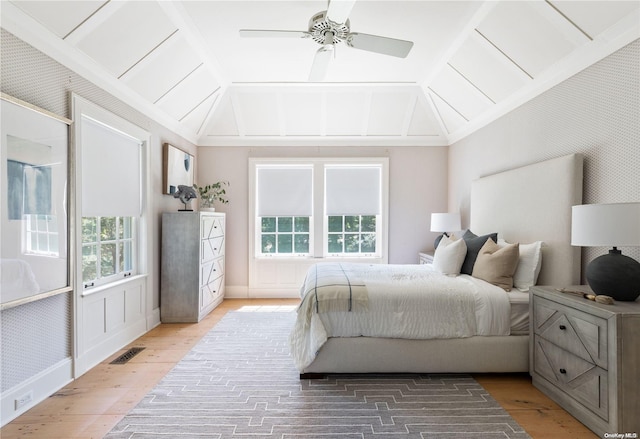 bedroom with wood-type flooring, vaulted ceiling, and ceiling fan