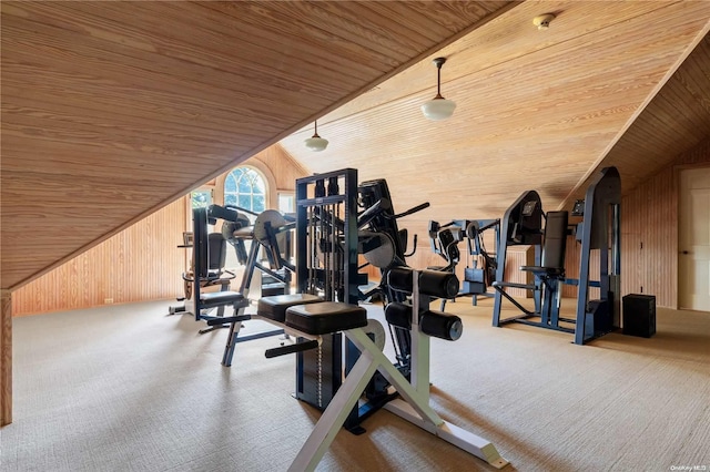 exercise area with wooden walls, wooden ceiling, and vaulted ceiling