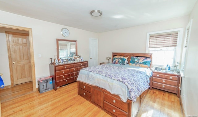 bedroom with multiple windows and light wood-type flooring