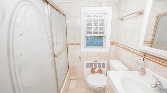 full bathroom with vanity, radiator, tile patterned flooring, toilet, and tile walls