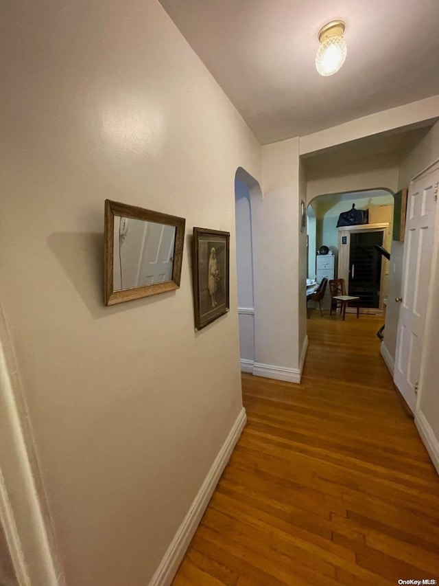 hall with hardwood / wood-style floors