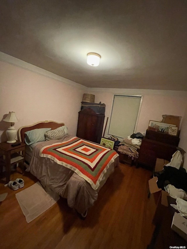 bedroom featuring dark wood-type flooring and vaulted ceiling