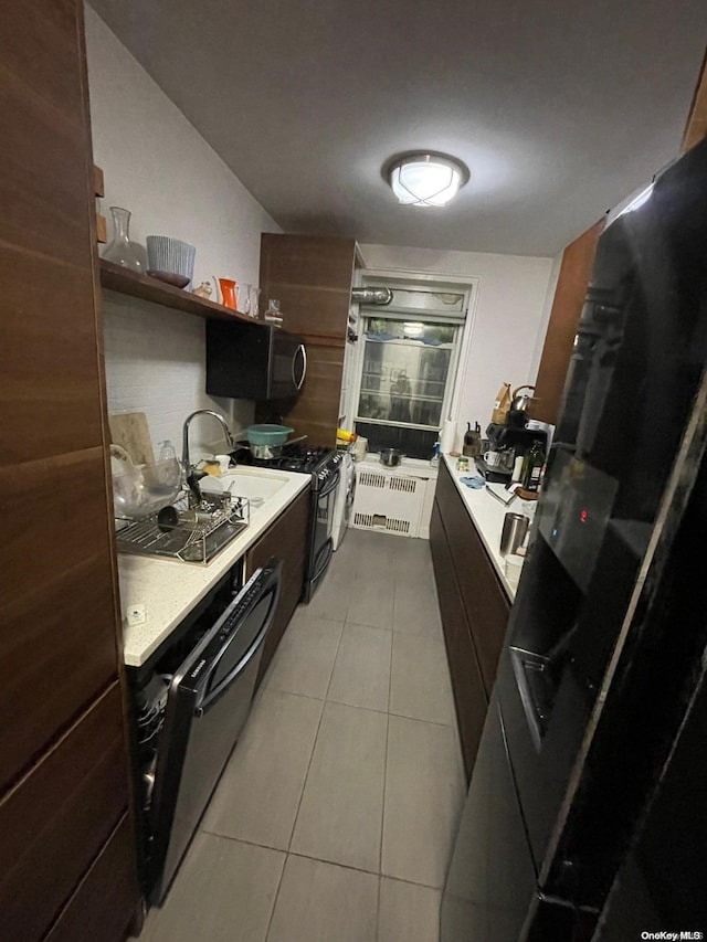 kitchen featuring light tile patterned flooring and sink