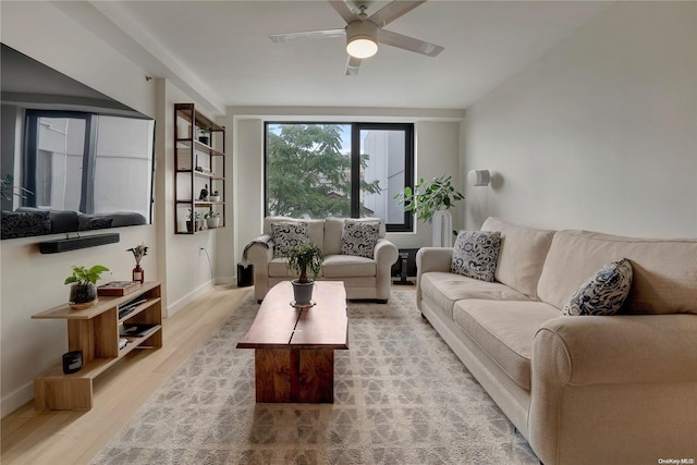 living room with light hardwood / wood-style floors and ceiling fan