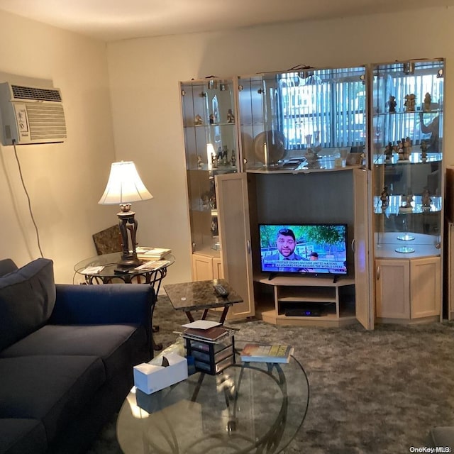 carpeted living room featuring an AC wall unit