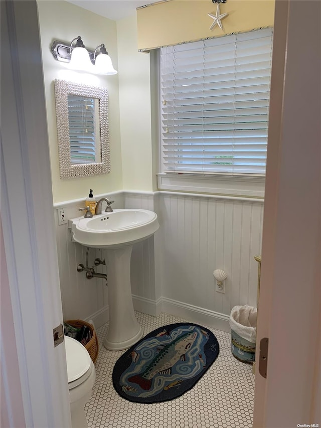 1 Canal Rd, Hampton Bays, NY 11946 - bathroom featuring a wainscoted wall, toilet, and tile patterned flooring