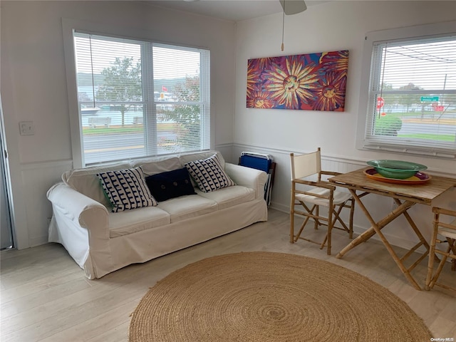1 Canal Rd, Hampton Bays, NY 11946 - living room with light wood finished floors, wainscoting, a ceiling fan, and a decorative wall