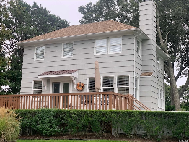 1 Canal Rd, Hampton Bays, NY 11946 - back of house with a chimney, a wooden deck, and roof with shingles