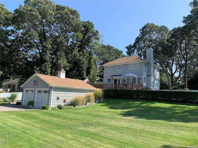 1 Canal Rd, Hampton Bays, NY 11946 - view of green lawn with a garage and an outbuilding