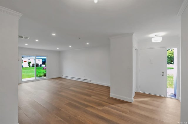 interior space with hardwood / wood-style flooring, crown molding, and a baseboard radiator