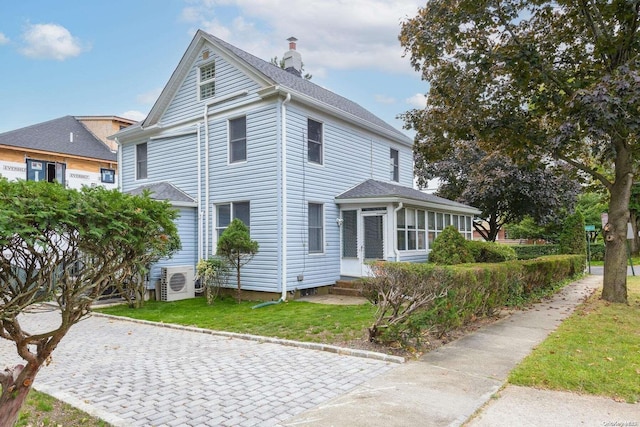 view of property exterior featuring a lawn and ac unit