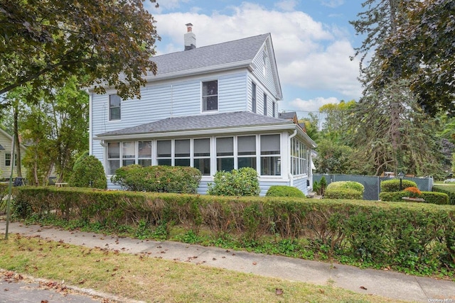 view of front of house featuring a sunroom