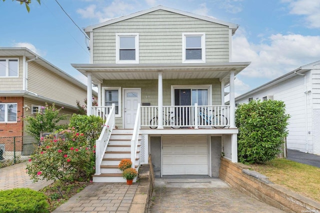 view of front of house featuring covered porch and a garage