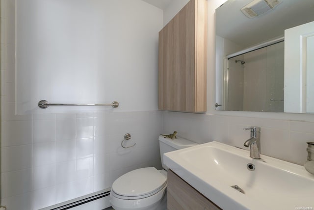 bathroom featuring walk in shower, a baseboard heating unit, toilet, vanity, and tile walls