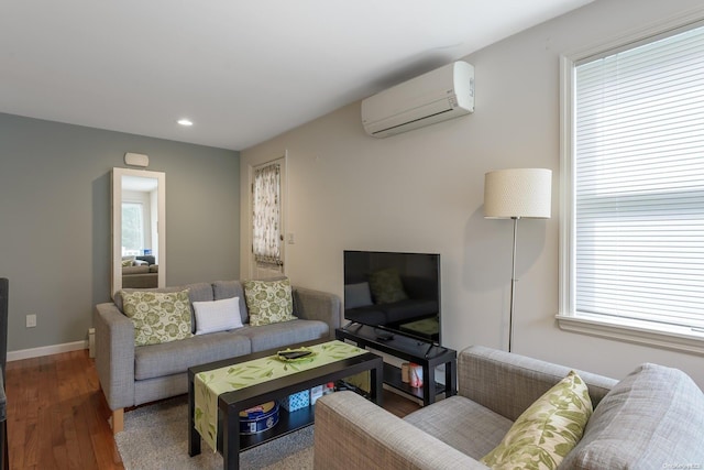 living room featuring a wall unit AC and hardwood / wood-style floors