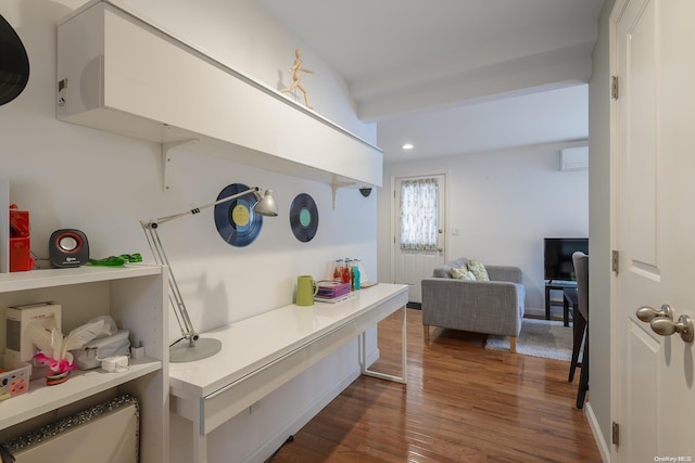 interior space with a wall unit AC and dark wood-type flooring