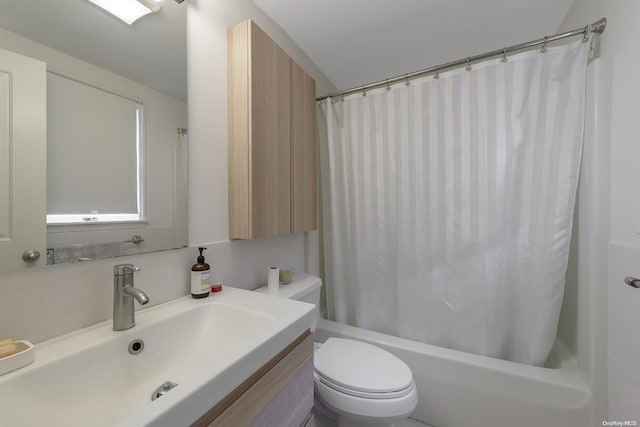 full bathroom featuring vanity, shower / bath combination with curtain, and toilet