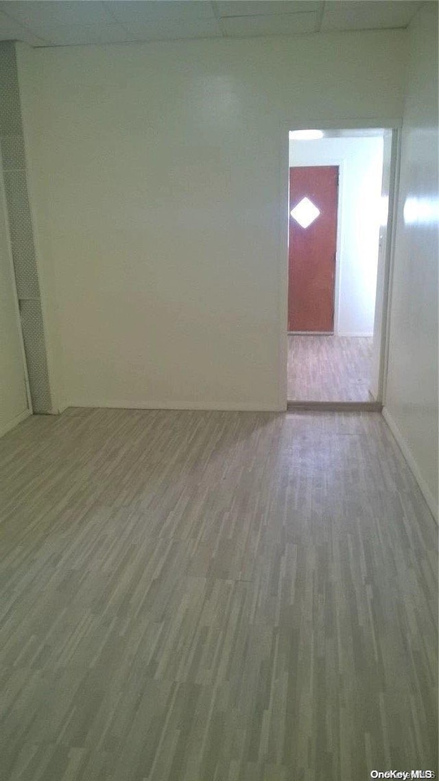 unfurnished room with wood-type flooring