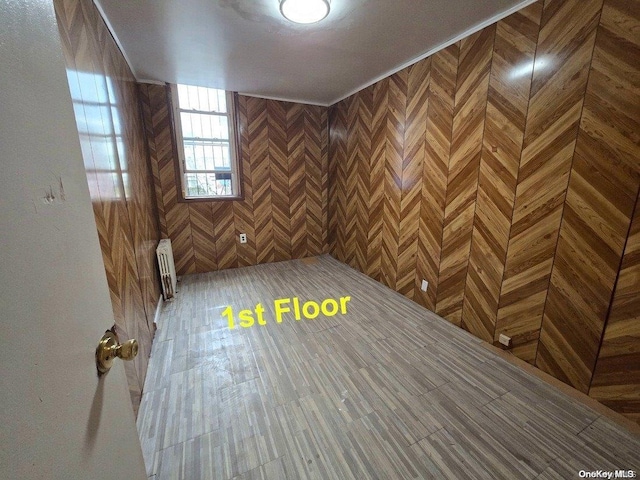 interior space with wood-type flooring and radiator