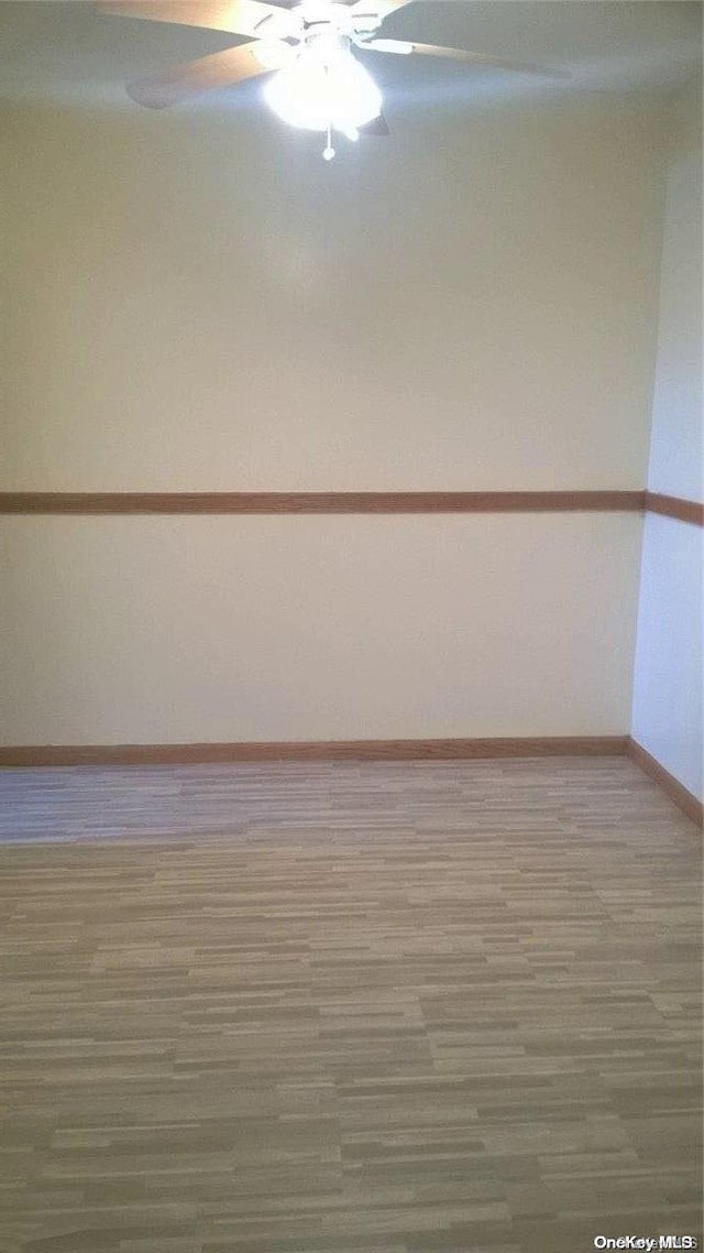 unfurnished room with hardwood / wood-style floors and ceiling fan