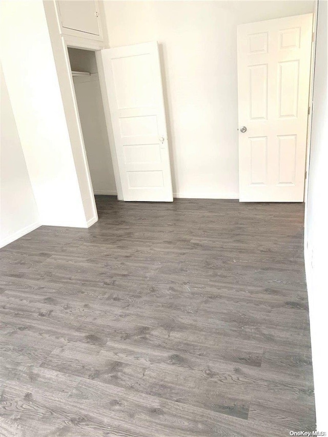 unfurnished room featuring dark wood-type flooring