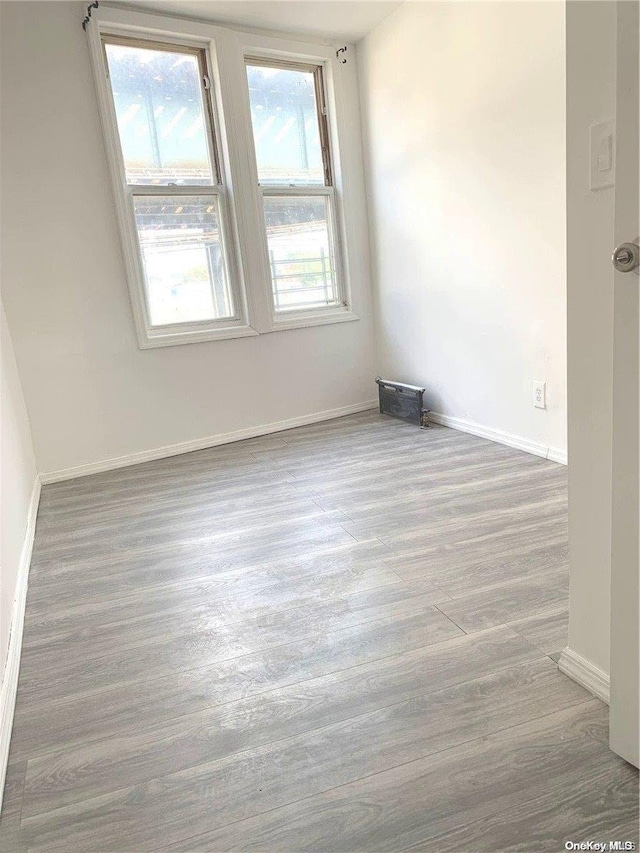 spare room with hardwood / wood-style flooring