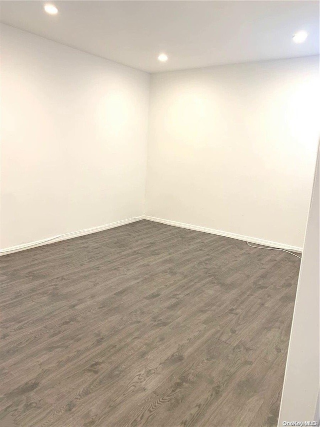 spare room with dark wood-type flooring