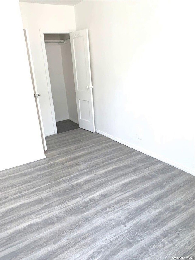 unfurnished room with dark hardwood / wood-style floors