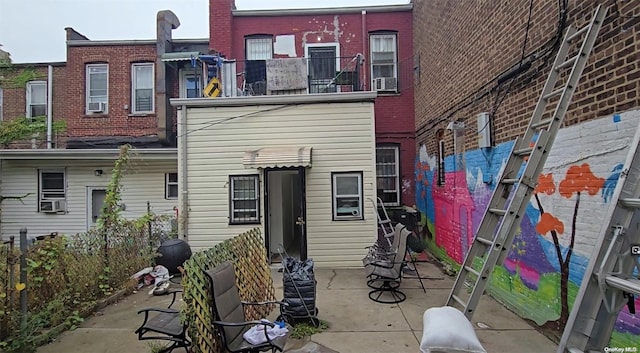 rear view of house featuring cooling unit