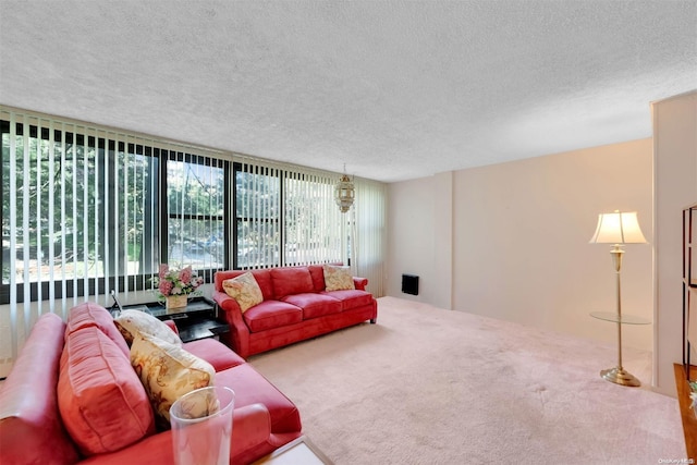 living room with carpet flooring, a wall of windows, and a textured ceiling