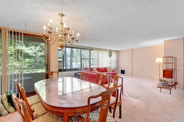 carpeted dining area featuring a textured ceiling and a chandelier