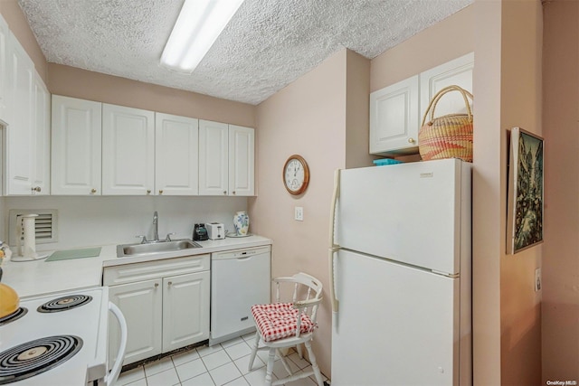 kitchen featuring white cabinets, light tile patterned floors, white appliances, and sink