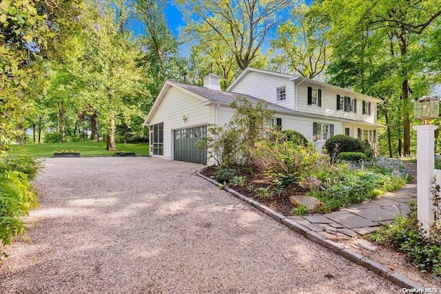 view of side of home with a yard and a garage