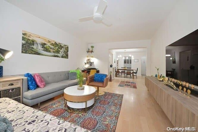 living room featuring ceiling fan and light hardwood / wood-style floors