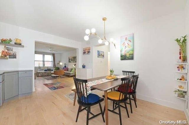 dining room featuring light hardwood / wood-style floors and an inviting chandelier