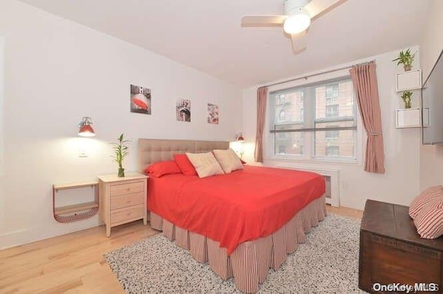 bedroom with ceiling fan and light hardwood / wood-style flooring