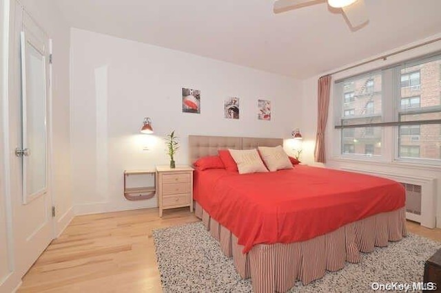 bedroom with ceiling fan and hardwood / wood-style flooring