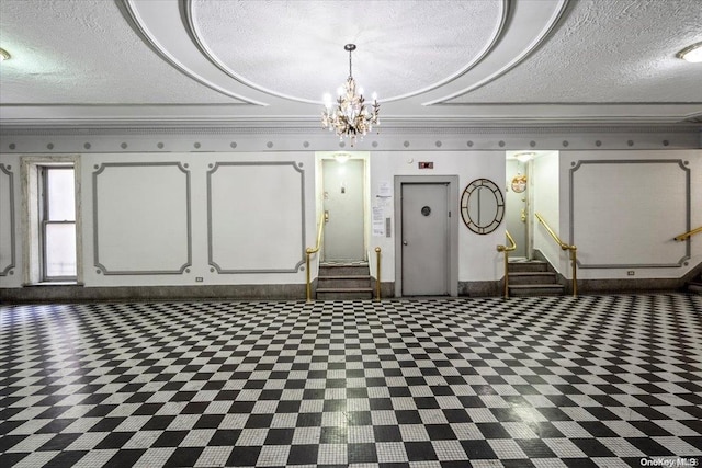 basement with a textured ceiling, elevator, and a chandelier