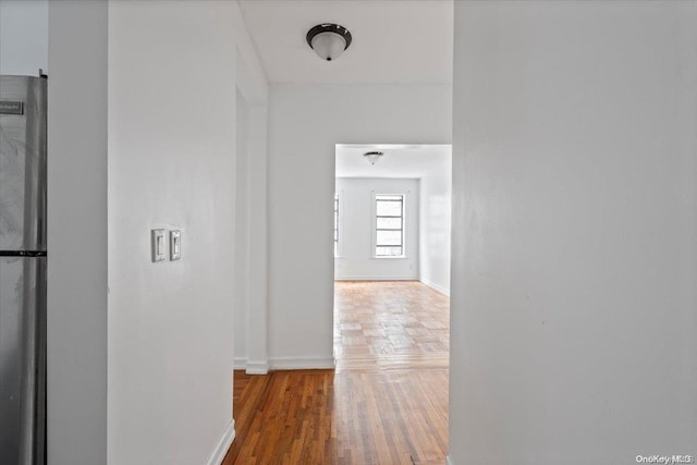 hall with hardwood / wood-style flooring