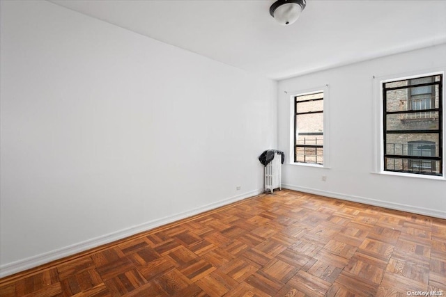 empty room featuring dark parquet flooring